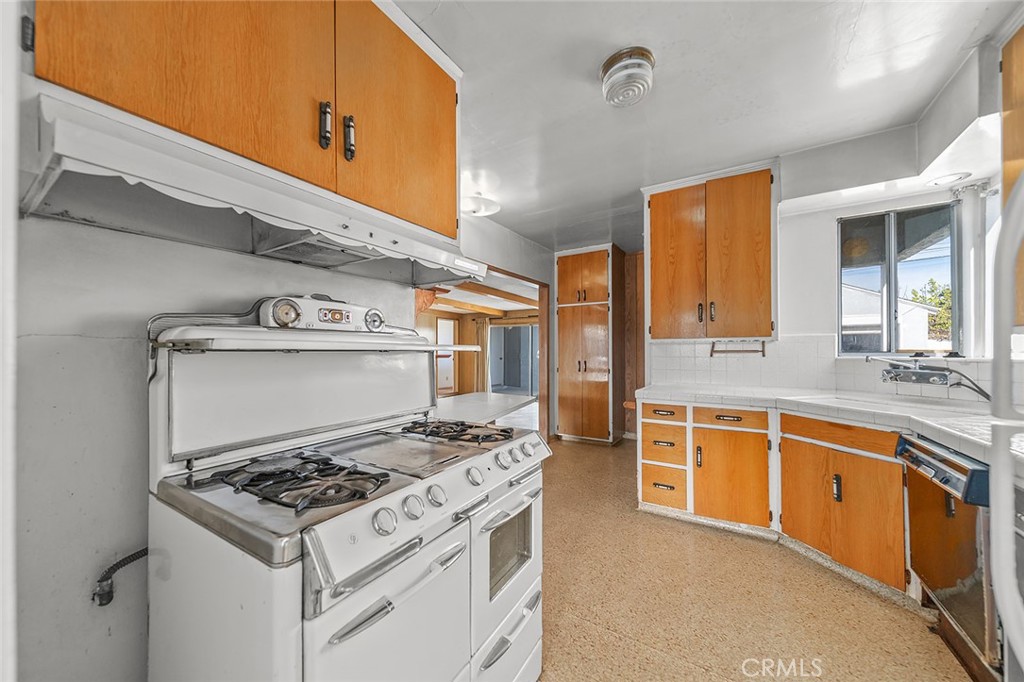 4224 Falcon Avenue Long Beach, CA 90807 - Photo 3 of 16 a kitchen with stainless steel appliances granite countertop a stove and a sink