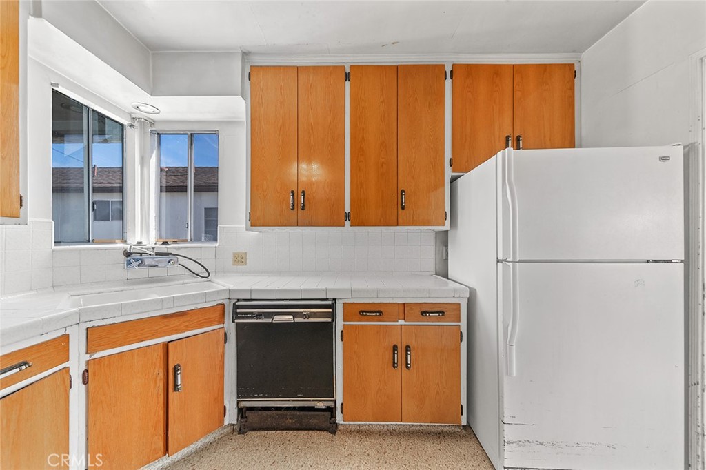 4224 Falcon Avenue Long Beach, CA 90807 - Photo 4 of 16 a kitchen with a refrigerator sink and cabinets