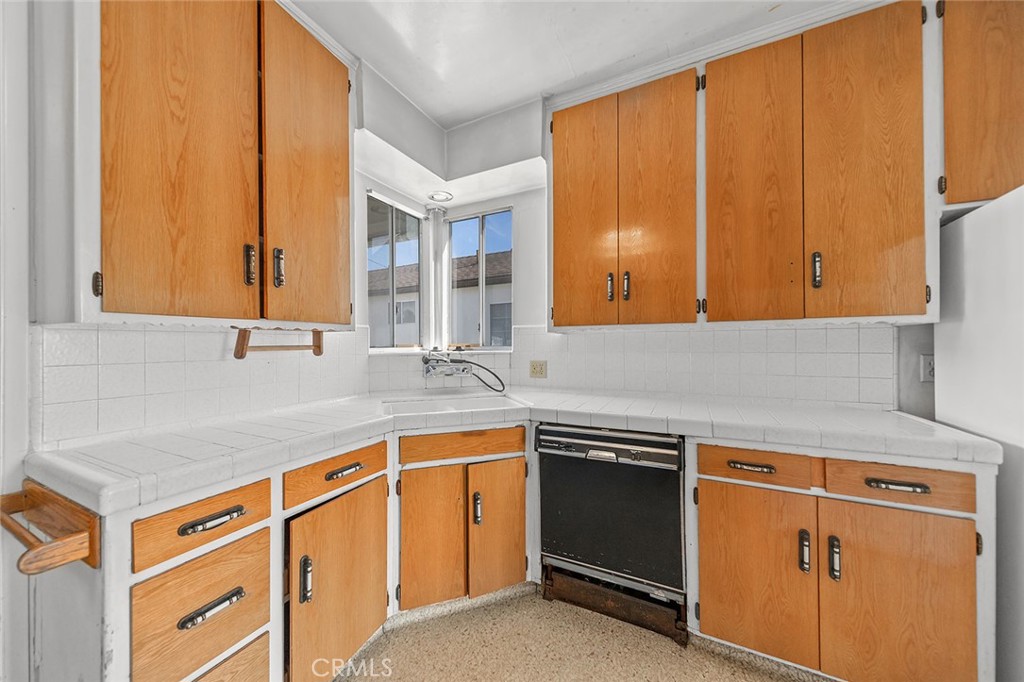 4224 Falcon Avenue Long Beach, CA 90807 - Photo 5 of 16 a kitchen with stainless steel appliances granite countertop a sink and a microwave