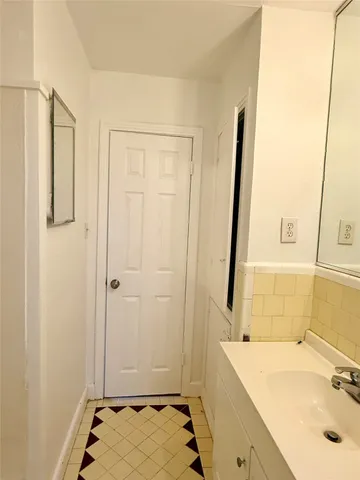 a view of a room with wooden floor and fan