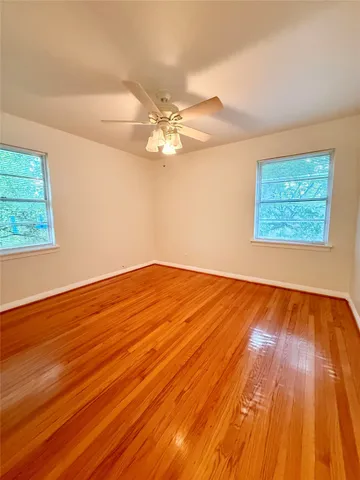 a view of a room with wooden floor and cabinet