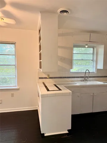 a room with two sink and a window