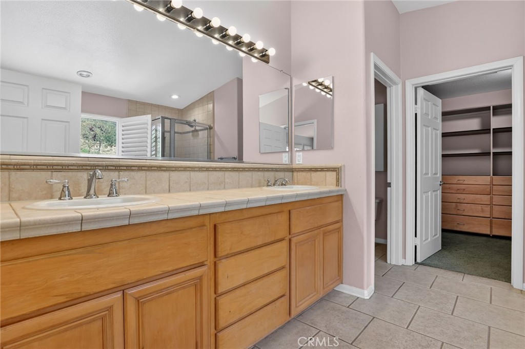 20543 Pesaro Porter Ranch Porter Ranch, CA 91326 - Photo 38 of 67 a bathroom with a sink and a mirror
