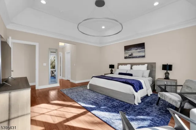 a bedroom with a bed and a chandelier