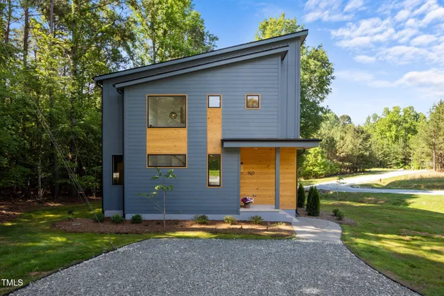 a view of house with backyard space and garden