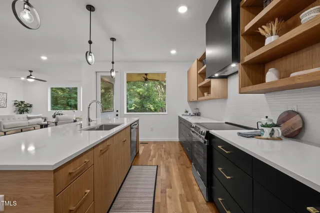 a kitchen with sink stove and cabinets