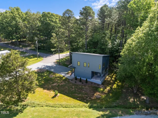 aerial view of a house with swimming pool and a yard