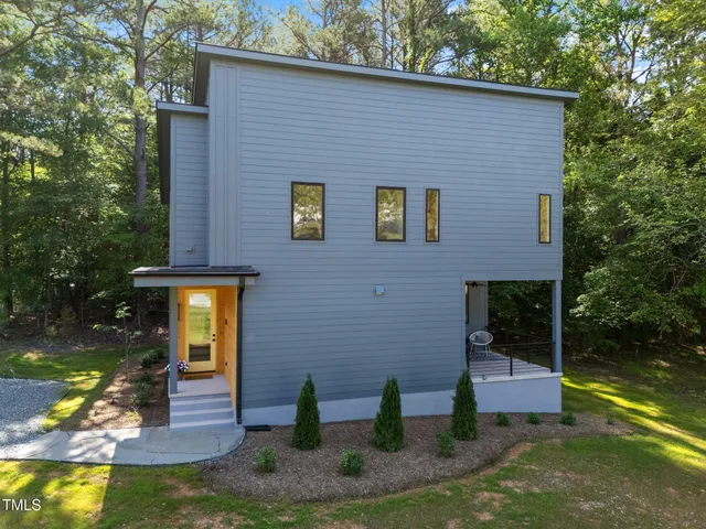 a view of backyard of house with green space