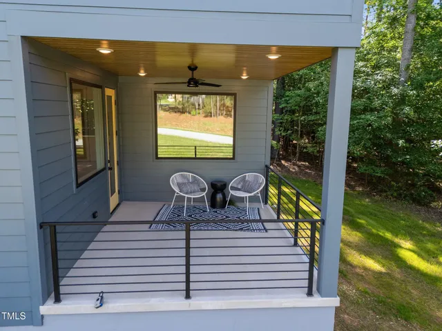a backyard of a house with table and chairs