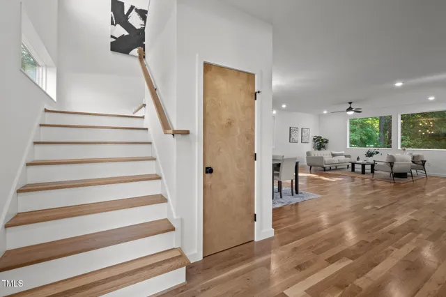 a view of a livingroom with furniture and stairs