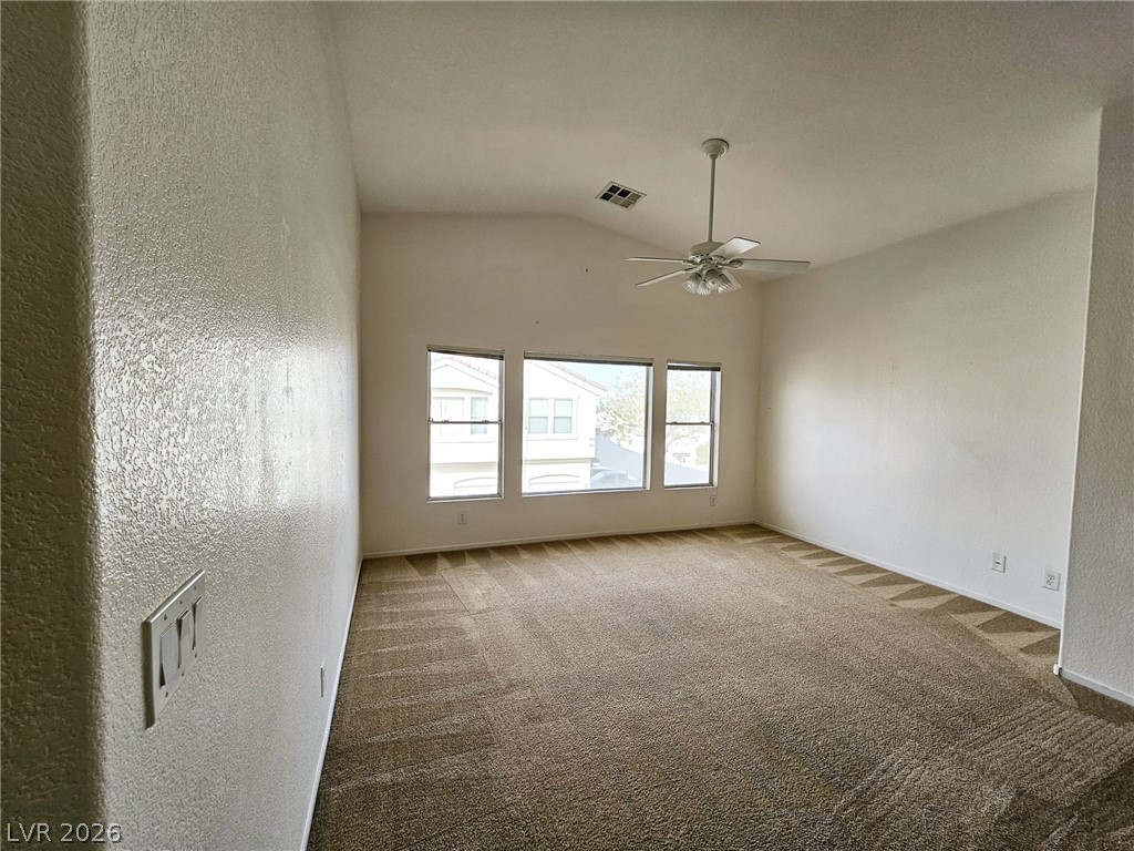 1663 Lefty Garcia Way Henderson, NV 89002 - Photo 23 of 31 A spacious room features a vaulted ceiling and ample natural light from three large windows.