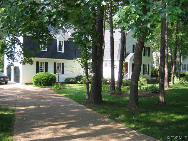 10706 Green Mt Road Richmond, VA 23238 - Photo 1 of 9 a front view of a house with a yard and trees