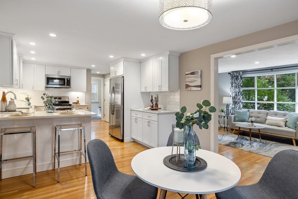 34 Tower Road Lexington, MA 02421 - Photo 7 of 35 a kitchen with refrigerator cabinets dining table and chairs