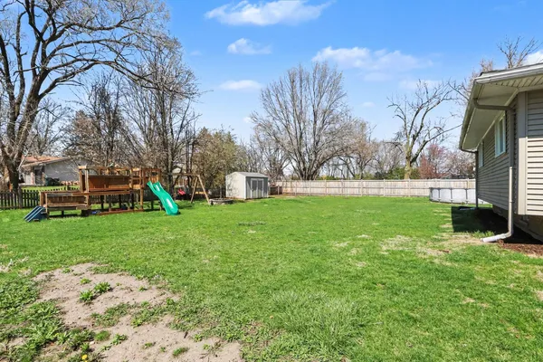 a view of yard with swimming pool and green space