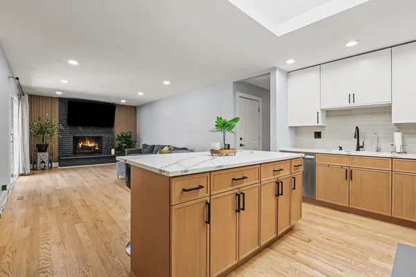 a kitchen with sink a stove and cabinets