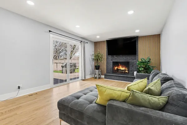a living room with furniture a flat screen tv and a fireplace