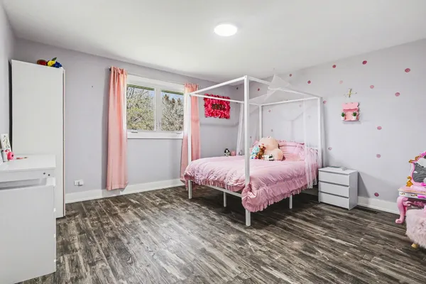a spacious bedroom with a bed and a window
