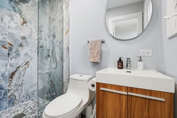 a white toilet sitting next to a bathroom sink