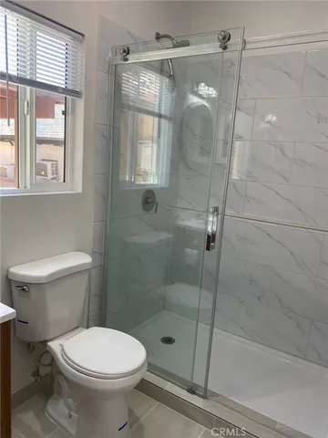 a bathroom with a toilet and a shower