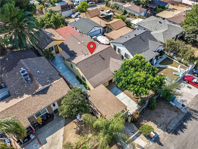 an aerial view of a house with a yard