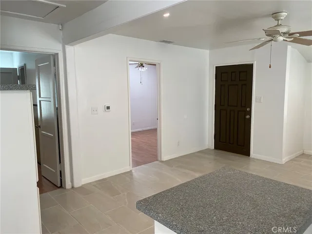 an empty room with closet and a hallway