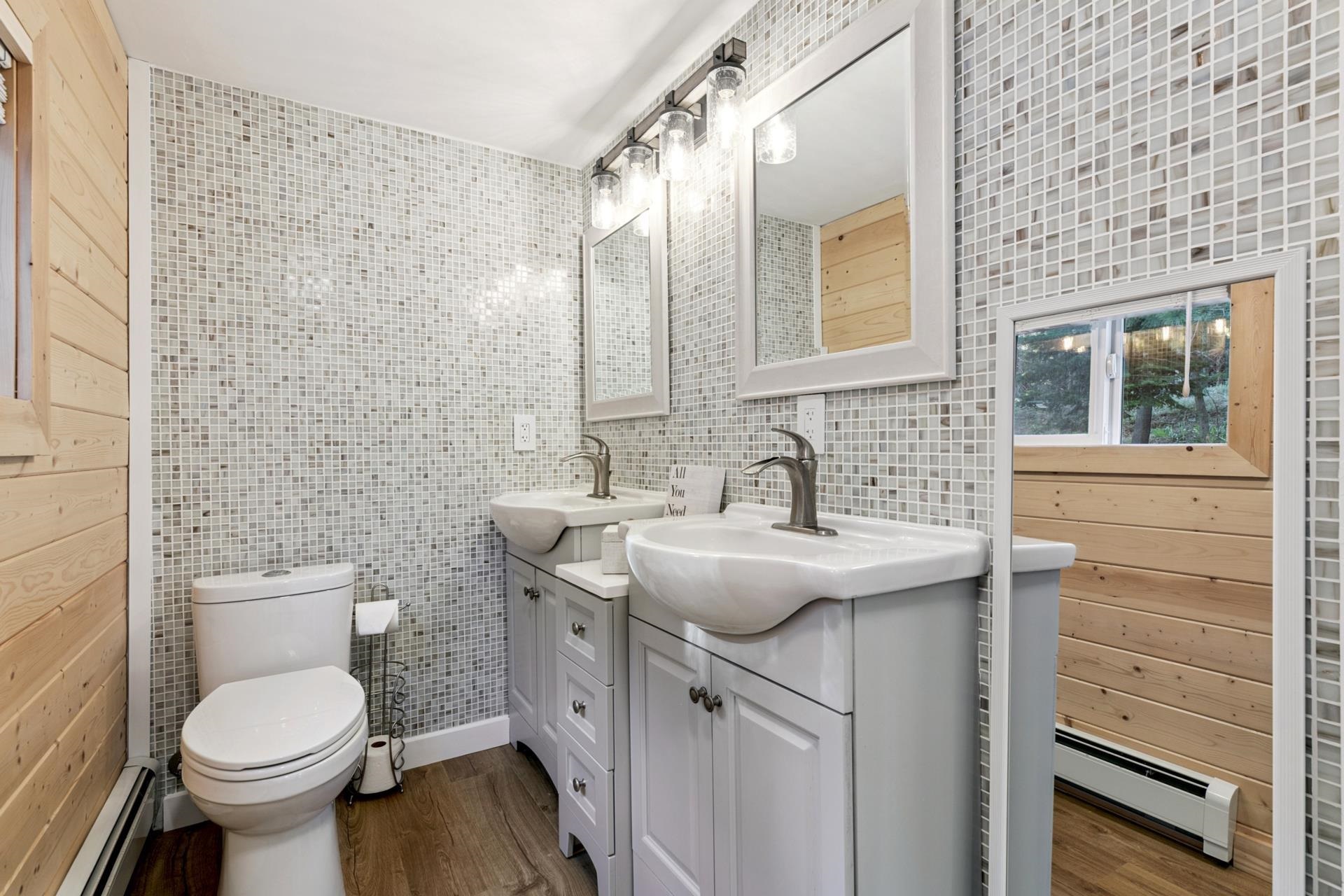 7594-7598 River Road Truckee, CA 96161 - Photo 22 of 27 a bathroom with a toilet sink and mirror