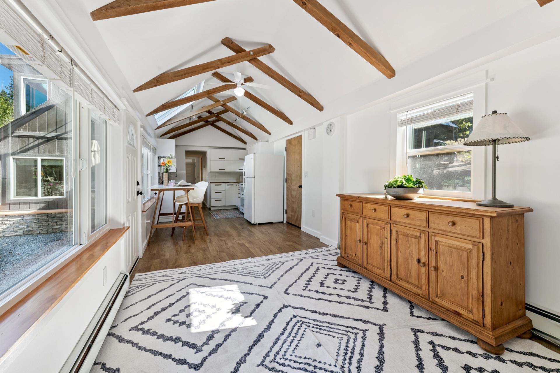 7594-7598 River Road Truckee, CA 96161 - Photo 7 of 27 a bedroom with furniture and a chandelier