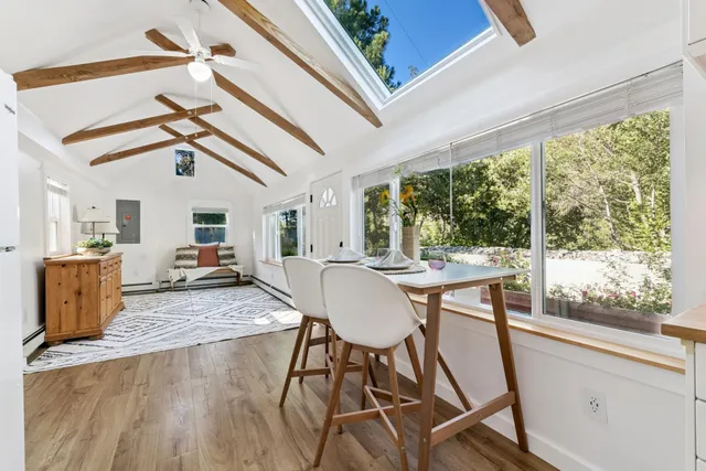 a view of a dining room with furniture window and wooden floor