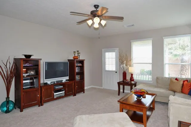a living room with furniture and a chandelier