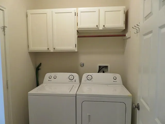 a view of an empty room with a cabinet
