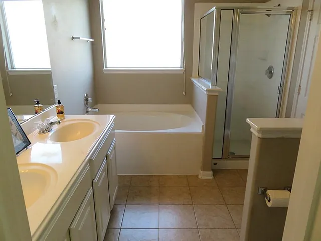 a bathroom with a double vanity sink mirror and toilet