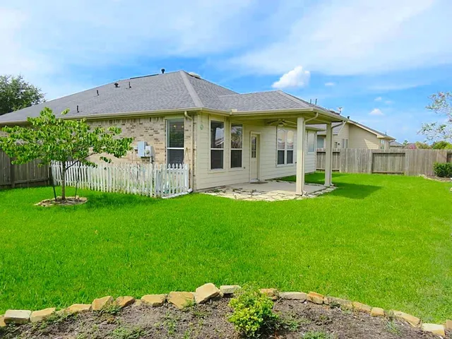 a view of a house with a backyard porch and sitting area