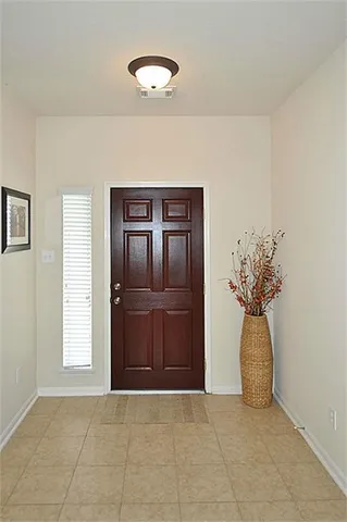 a view of a dining room with a table and chairs