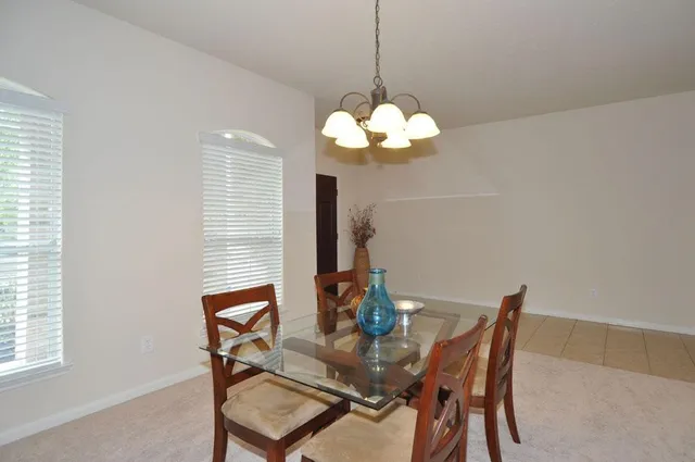 a dining room with furniture and window
