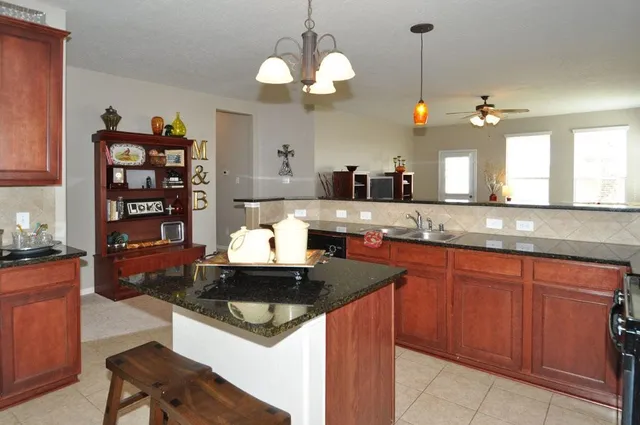 a living room with furniture a flat screen tv and a window