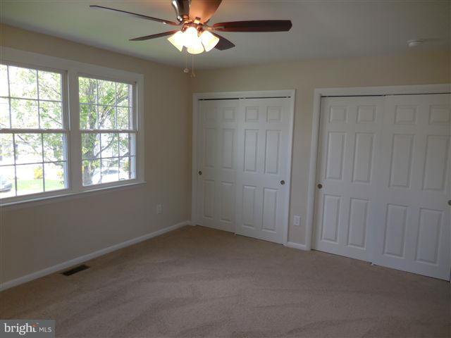 517 Shipley Road Linthicum, MD 21090 - Photo 13 of 30 an empty room with windows and fan