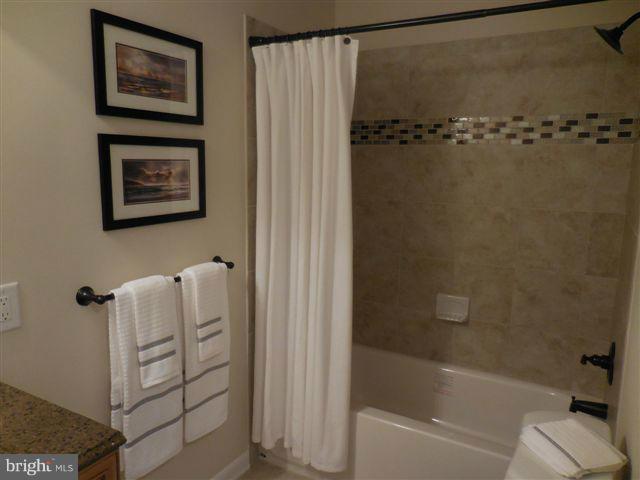 517 Shipley Road Linthicum, MD 21090 - Photo 17 of 30 a bathroom with a shower and a bath tub