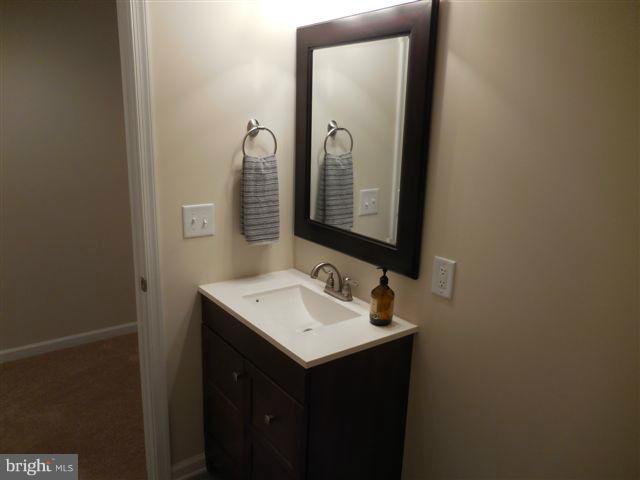 517 Shipley Road Linthicum, MD 21090 - Photo 23 of 30 a bathroom with a sink and a mirror