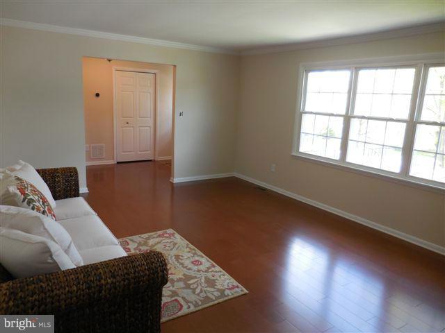 517 Shipley Road Linthicum, MD 21090 - Photo 6 of 30 wooden floor in an empty room with a window