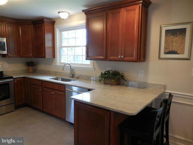 517 Shipley Road Linthicum, MD 21090 - Photo 10 of 30 a kitchen with a sink cabinets and window