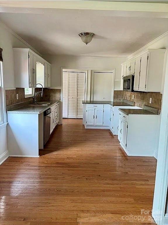 3129 Sims Road Rock Hill, SC 29730 - Photo 3 of 23 a kitchen with stainless steel appliances granite countertop a sink stove and wooden floor