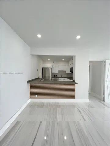 a room with a walk in closet and wooden floor
