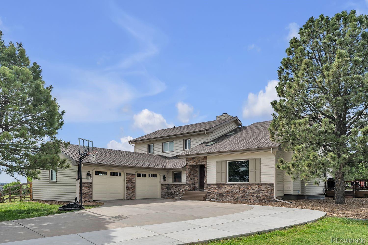 a front view of a house with yard and trees