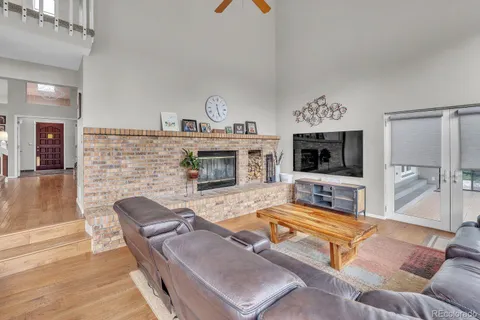 a living room with furniture flat screen tv and a fireplace