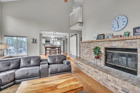 a living room with furniture a fireplace and a table