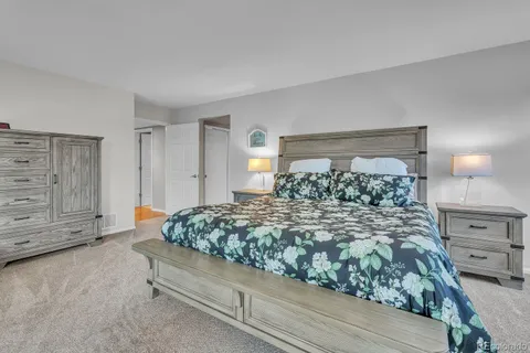 a bed room with a bed and a dresser