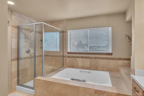 a bathroom with a bathtub and a shower