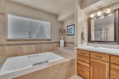 a bath tub sitting next to a bathroom sink