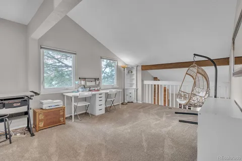a view of a livingroom with workspace and a window