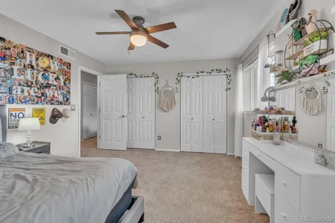 a bedroom with a bed a window and dresser
